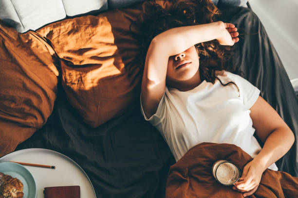 woman tired in bed hypothyroidism